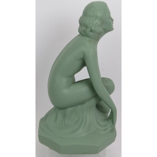 23 - An Art Deco plaster figure of a crouching nude with green painted finish. Incised mark 522 UB. Heigh... 