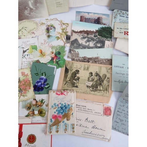 243 - A collection of early 20th century Christmas, greetings and memorial cards along with some local pos... 