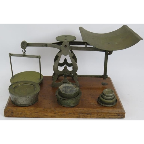 248 - A set of vintage English 7lb parcel postal scales mounted on an oak stand with weights. Height 23cm.... 