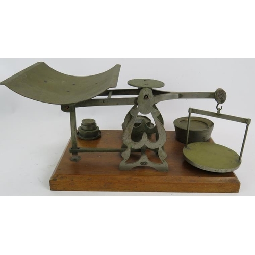 248 - A set of vintage English 7lb parcel postal scales mounted on an oak stand with weights. Height 23cm.... 