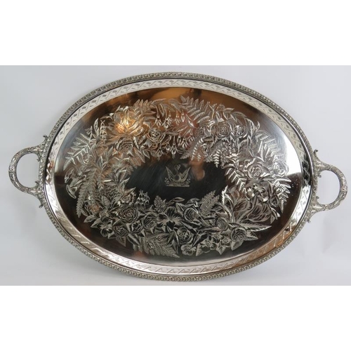 249 - A large Victorian silver plated oval tray with engraved detail and family crest to centre. Marked Ma... 