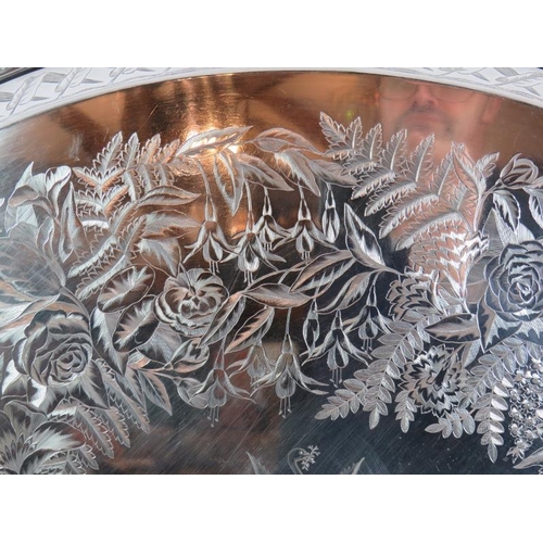 249 - A large Victorian silver plated oval tray with engraved detail and family crest to centre. Marked Ma... 