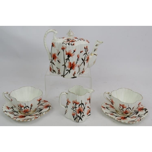 254 - Wileman & Co (Foley) pre Shelley fluted teapot, jug and two cups and saucers decorated with flowers.... 