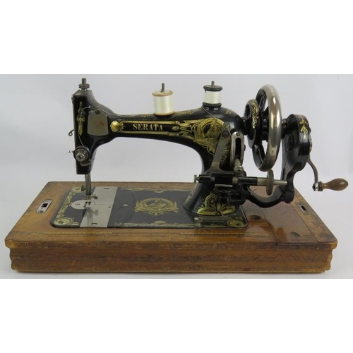 262 - A vintage Serata manual sewing machine with wooden case, key and instructions.
Condition report: Unt... 