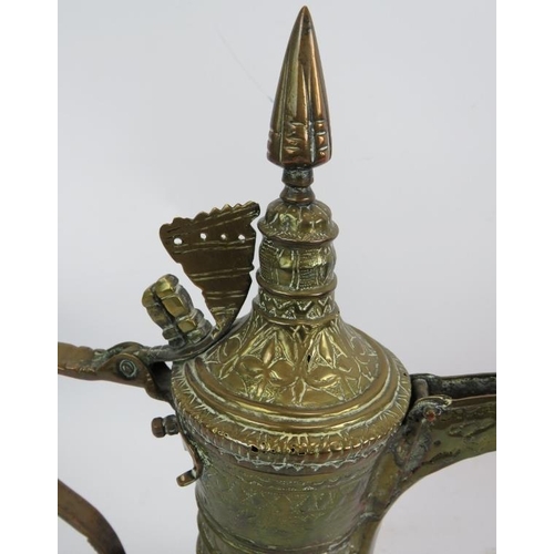 269 - A finely decorated antique copper and brass middle Eastern Dallah  coffee pot and a similar brass Da... 