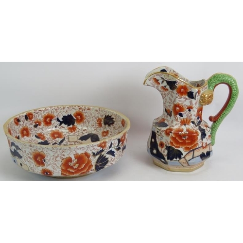 276 - A large Ironstone toilet jug and bowl set decorated in Imari colours and with a dragon form handle. ... 