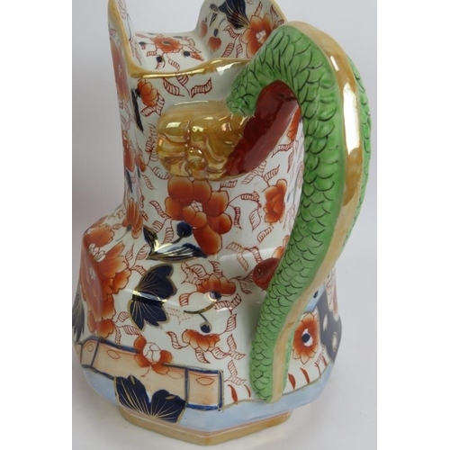 276 - A large Ironstone toilet jug and bowl set decorated in Imari colours and with a dragon form handle. ... 