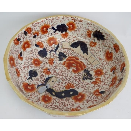 276 - A large Ironstone toilet jug and bowl set decorated in Imari colours and with a dragon form handle. ... 