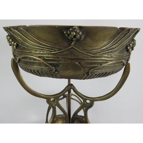 278 - A contemporary Art Nouveau style cast bronze table centre of tripod form consisting of one large bow... 