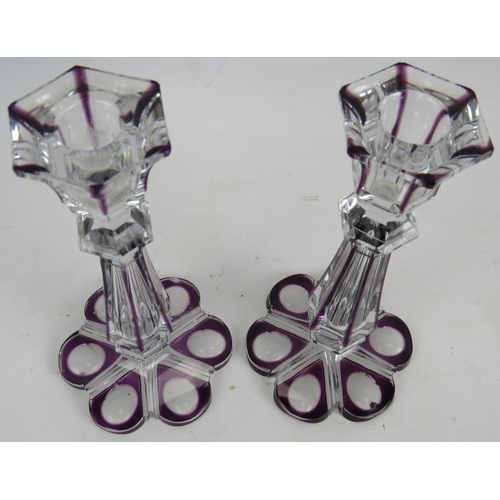 280 - A pair of Bohemian crystal flash cut amethyst candle sticks with hollow stems and petal shapes bases... 