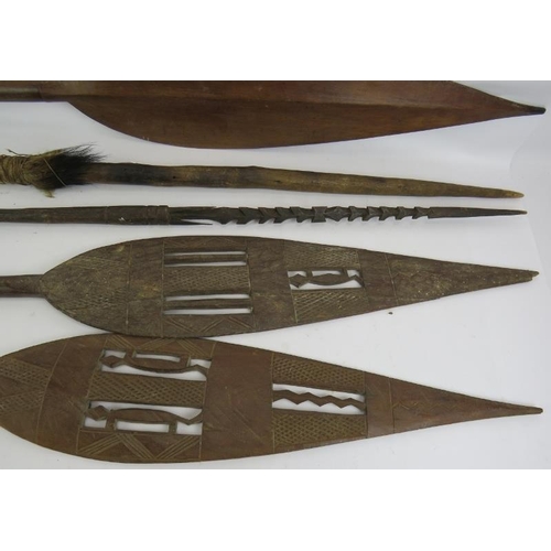 29 - A hand carved Papua New Guinea Harpoon spear, a similar javelin spear, two carved ceremonial spears ... 