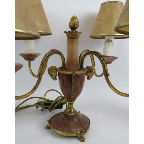 32 - A marble and gilt brass four arm table lamp with ram's head decoration, and a pair of cast pewter ur... 