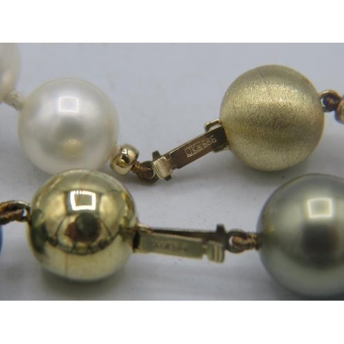 324 - A strand of South sea shell pearl necklace. Individually knotted with a 14ct yellow gold ball clasp.... 