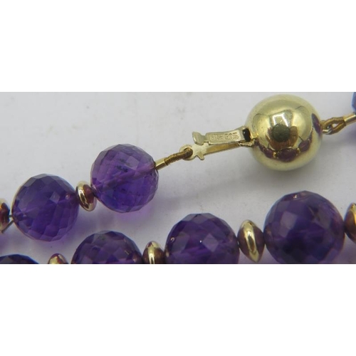 326 - A fine quality faceted amethyst necklace with yellow metal spacers, 14ct yellow gold ball clasp and ... 