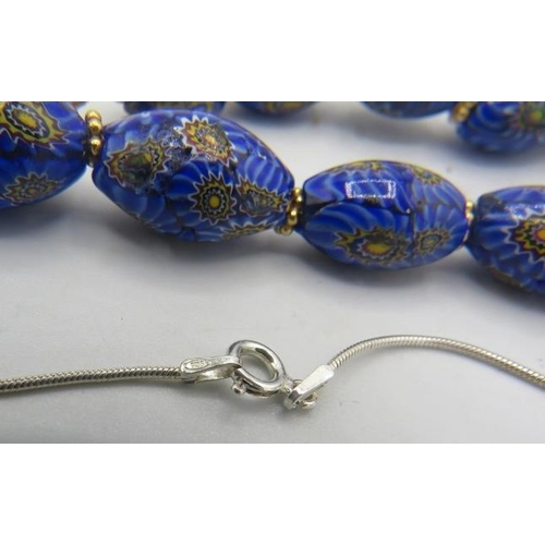 335 - A venetian milliflora blue glass bead necklace with yellow metal hook clasp and an amber style heart... 