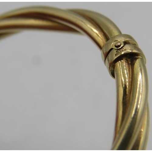 339 - A 9ct yellow gold bangle with three tube twist design and hinged clasp, approx weight 12 grams. Insu... 