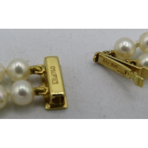 348 - A double strand pearl necklace of uniform size, with 18ct yellow gold clasp and 3 18ct gold and diam... 