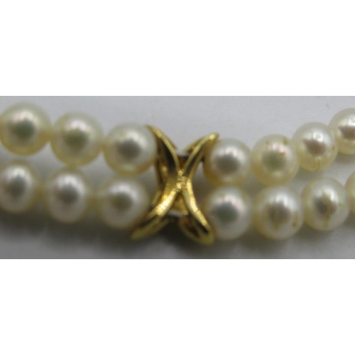 348 - A double strand pearl necklace of uniform size, with 18ct yellow gold clasp and 3 18ct gold and diam... 