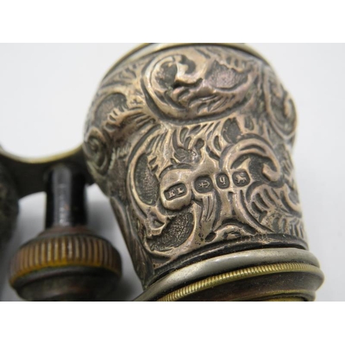 368 - A pair of heavily embossed silver binoculars. Birmingham 1890.
Condition report: Part of the rim dam... 