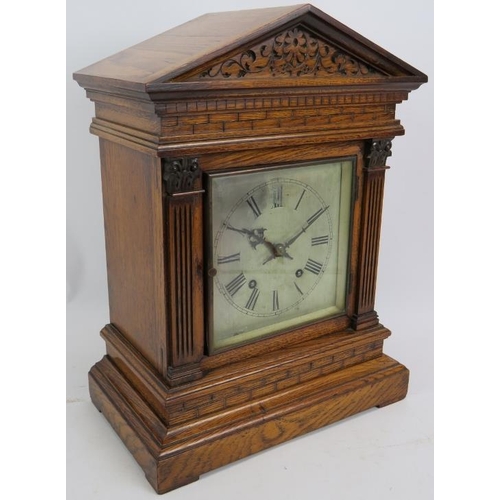 37 - An Edwardian oak cased Palladian style mantel clock with striking movement. Pendulum present. No key... 