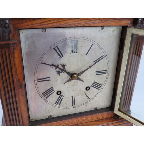 37 - An Edwardian oak cased Palladian style mantel clock with striking movement. Pendulum present. No key... 