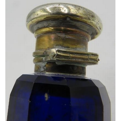 375 - A double ended blue glass scent/smelling salts bottle with white metal tops.
Condition report: One t... 