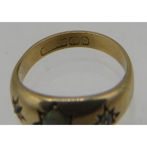 396 - An opal and diamond star set gold ring. Possibly 18ct yellow gold. Hall marks worn. Size K. 4.7 gram... 