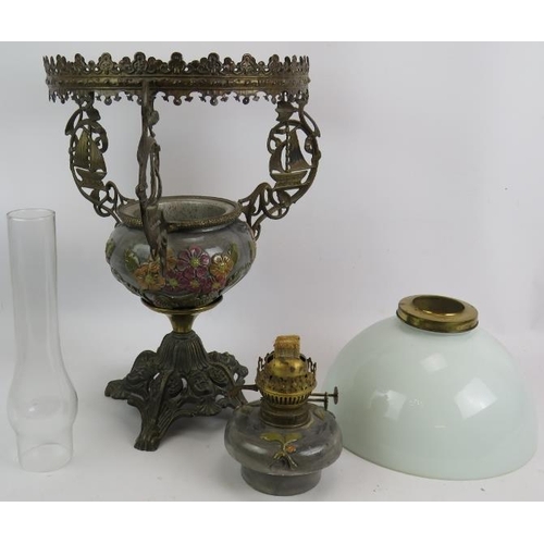 40 - A highly decorative oil lamp with relief moulded pottery reservoir cast brass stand and opaline glas... 