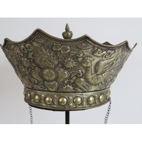 41 - A Chinese white metal ceremonial crown shaped hat with phoenix and dragon repousse decoration. Bespo... 