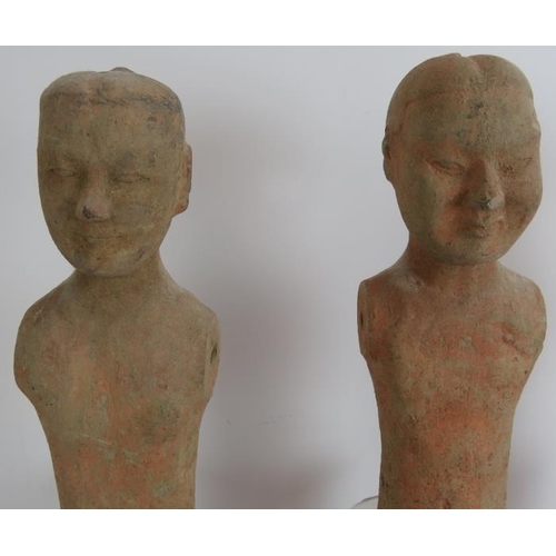 42 - A series of three early Chinese pottery male figures, probably tomb attendants, in the Han/Tang styl... 