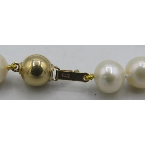 424 - A strand of individually knotted freshwater cultured pearls with 9ct yellow gold ball clasp. Approx:... 