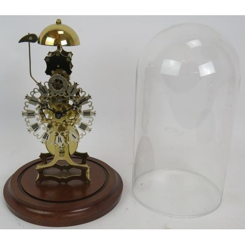 47 - A contemporary brass skeleton clock with German striking movement under a glass dome. No key. Overal... 