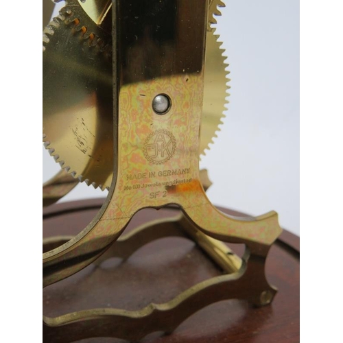 47 - A contemporary brass skeleton clock with German striking movement under a glass dome. No key. Overal... 