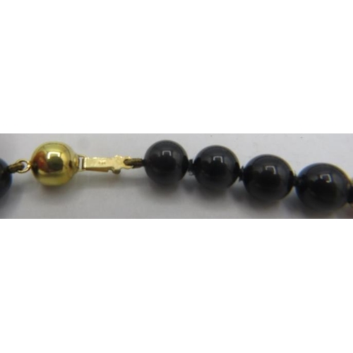 471 - A black onyx, lapis lazuli and cornelian necklace with 14 yellow metal spacers and on a 9ct yellow g... 