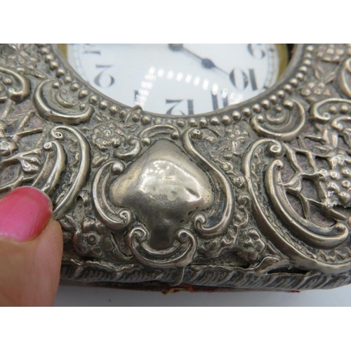 487 - A silver cased pocket watch holder, indistinct hallmarks, embossed with scrolls & foliate decoration... 