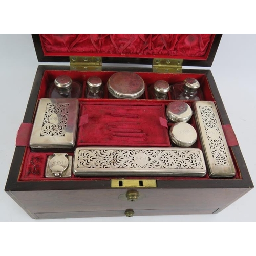 52 - A fine Regency Rosewood toilet box, fully fitted in red velvet with hallmarked silver topped jars, L... 