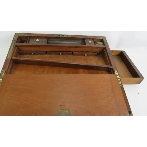 53 - A Regency period mahogany writing slope, brass bound with interior fittings, secret drawers and a do... 