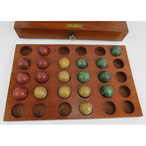 56 - An antique lotto type ball game consisting of box, numbered board and wooden balls. 27cm x 21cm x 18... 