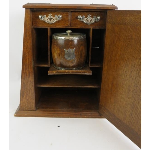 57 - An Edwardian oak smokers cabinet with plated mounts, two similar cigar/cigarette boxes and an antiqu... 