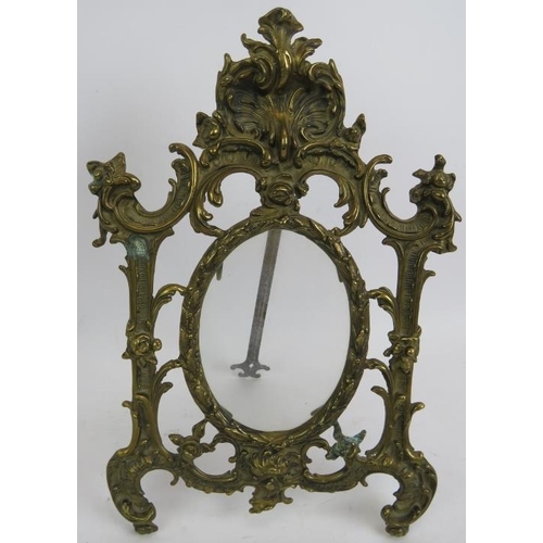 71 - A cast brass Rococo style easel picture frame and a carved shell double perfume bottle holder with g... 