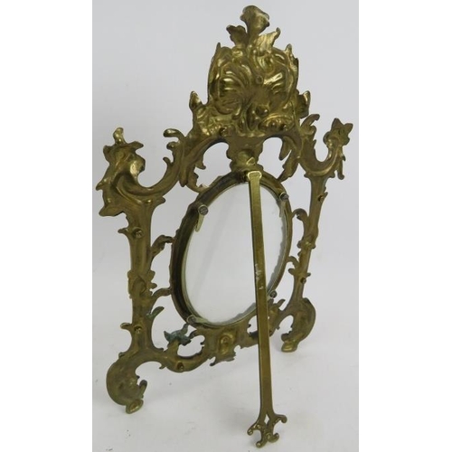 71 - A cast brass Rococo style easel picture frame and a carved shell double perfume bottle holder with g... 