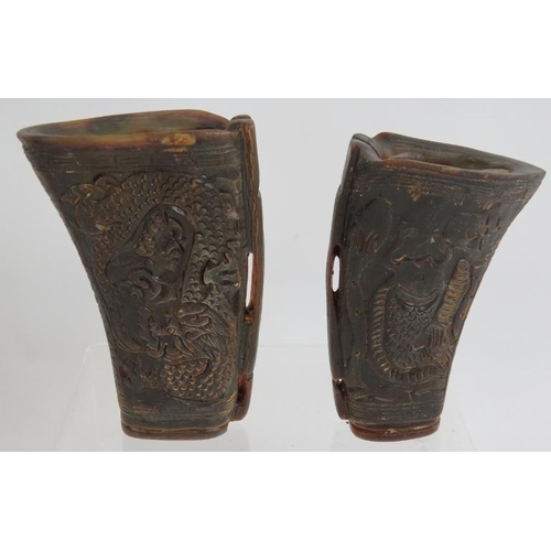 78 - A pair of Chinese carved buffalo horn libation cups one with dragon designs and one with koi carp. T... 