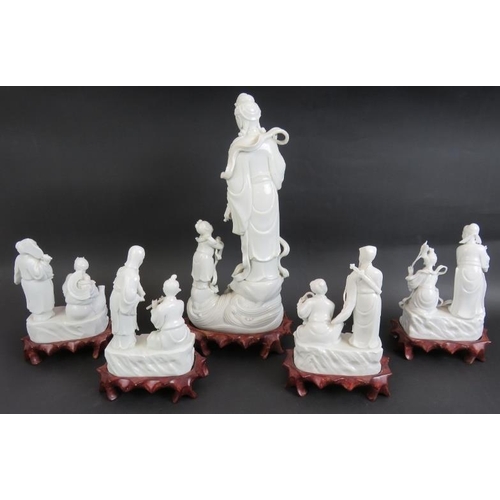 98 - A 20th century Chinese porcelain Blanc de Chine figure of Guan Yin on carved wooden stand and four o... 