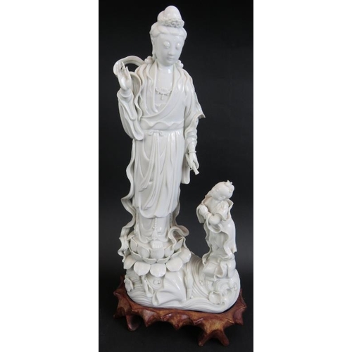 98 - A 20th century Chinese porcelain Blanc de Chine figure of Guan Yin on carved wooden stand and four o... 