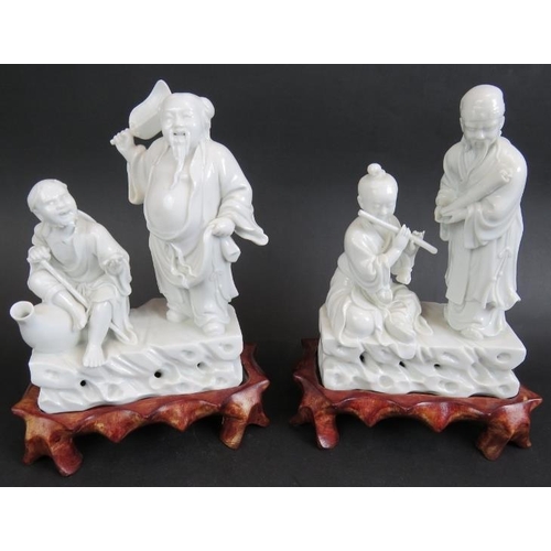 98 - A 20th century Chinese porcelain Blanc de Chine figure of Guan Yin on carved wooden stand and four o... 