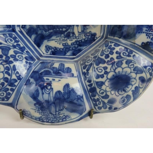 99 - An antique Chinese Delft ware blue and white dish with segmented petalled rim. Diameter 26cm.
Condit... 