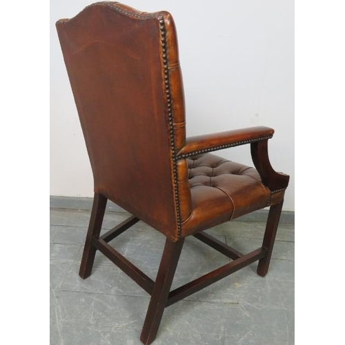 701 - A vintage 'Gainsborough' open-sided armchair, upholstered in tobacco brown buttoned leather with bra... 