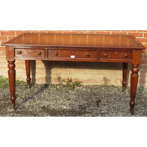 702 - A large Victorian mahogany writing desk, with inset gilt tooled tan leather writing surface, housing... 