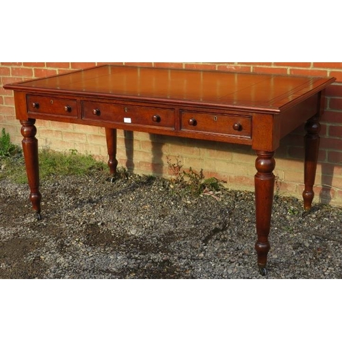 702 - A large Victorian mahogany writing desk, with inset gilt tooled tan leather writing surface, housing... 