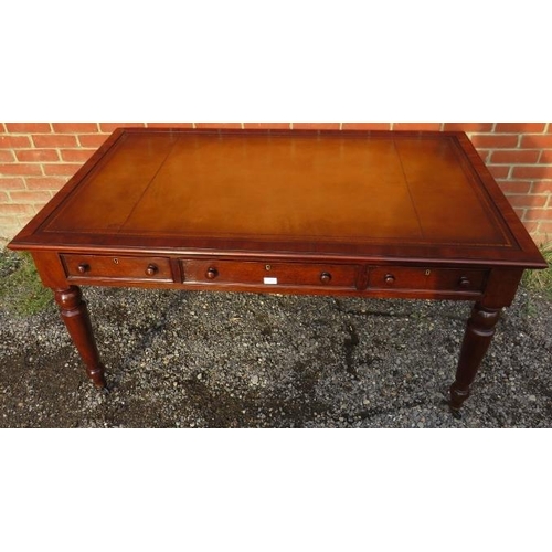 702 - A large Victorian mahogany writing desk, with inset gilt tooled tan leather writing surface, housing... 